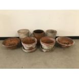 Seven terracotta garden pots, one pair with stands, a wide shallow pair, 40cm diameter, two taller