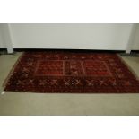 A 20th century Middle Eastern woollen carpet, 240cm by 160cm