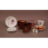 A collection of ceramic and treen collectables, including wooden storage containers, a glass hat