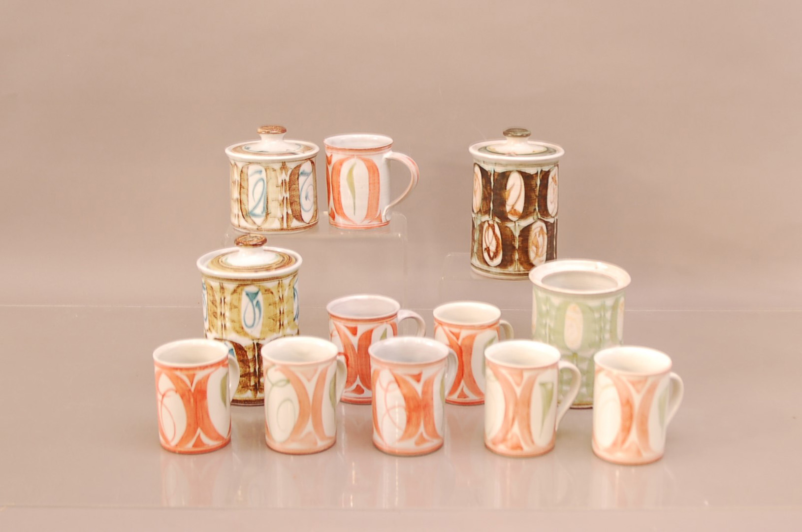 A collection of Aldermaston pottery, comprising, eight mugs 9.5cm high, three larger lidded jars (