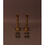 A pair of 19th century brass candlesticks, 23cm high, together with four silver 20th century