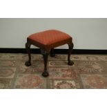 A 19th century walnut footstool, 53cm by 44cm, ball and claw feet with carved cabriole legs and