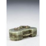 A 20th century carved jadeite jade kidney shaped box and lid, the id with a reclining mythical