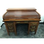 An Art Deco period Globe Wernicke roll top desk, currently locked and without a key, some damages,