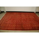 A 20th century Middle Eastern woollen Turkomen Tekke style carpet, 305cm by 215cm