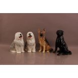 Four large Beswick porcelain dogs, comprising two sheepdogs, 30cm high, a German Shepherd and a