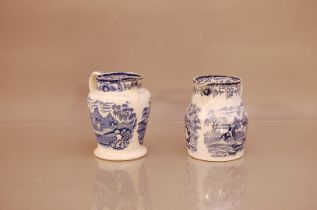 Two 19th century blue and white jugs, Indian Sporting style patterns, 16cm and 15.5cm high, AF one