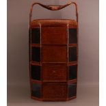 A 20th Century Chinese rattan and bamboo wedding or picnic carrier, with four compartments with