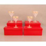 Four Baccarat glasses, in their Baccarat boxes (one AF), gilt scrolling design 16.5cm high (4)