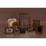 A collection of small photograph frames, including an art nouveau style white metal frame 27cm high,