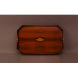 An early 20th century elongated hexagonal shaped mahogany and fruitwood tray, brass carrying