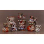 A collection of 19th century ceramic jugs, some by Masons, of differing sizes, the largest 26cm