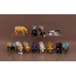 A collection of ceramic Cow Parade cows, comprising an assortment of cows, some American related
