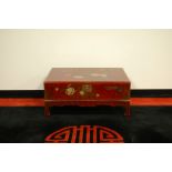 A modern Japanese lacquered coffee table, AF, 93cm by 70cm and 40cm high, damaged to top and sides