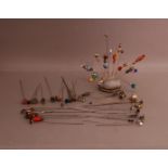 A large collection of hat pins, including ceramic, enamel and metal varieties (qty)