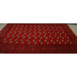 A 20th century Middle Eastern woollen Turkomen Tekke carpet, 287cm by 194cm