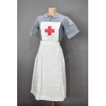 A vintage nurse's uniform, worn by D.P.White, two tunics, one with three stripes to the sleeve (