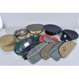 A collection of British and overseas hats including Peak Caps, Side Caps and berets, possibly some