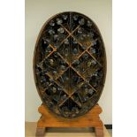 A 1980s German oak wine storage unit, the large barrel shaped oval on solid oak stand and having a