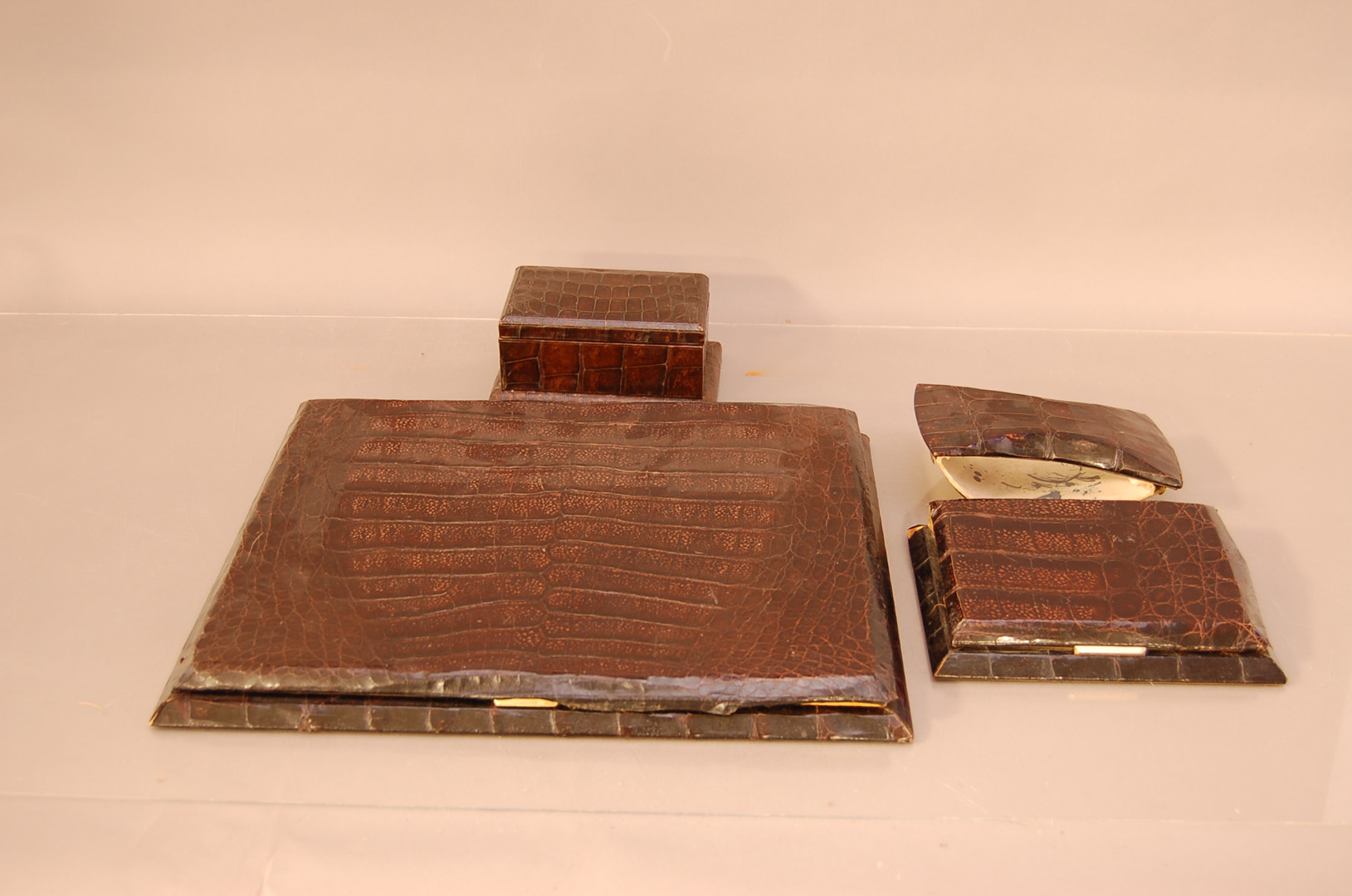 A group of c.1960's crocodile skin desk items, comprising a large hinged blotter (AF), 31cm x