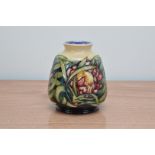 A Moorcroft pottery baluster vase, Proteus' pattern, 1999, 14.5cm high, in a retail box