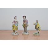 A pair of Sitzendorf porcelain figurines, male and female, the male figurine with a broken hand,