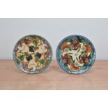 Two dated seconds Moorcroft pottery plates, 1998 and 1999, both 22cm in diameter in a retail box (