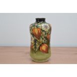 A Moorcroft pottery vase, Chinese Gooseberries' pattern, 1999, 22cm high, in a retail box