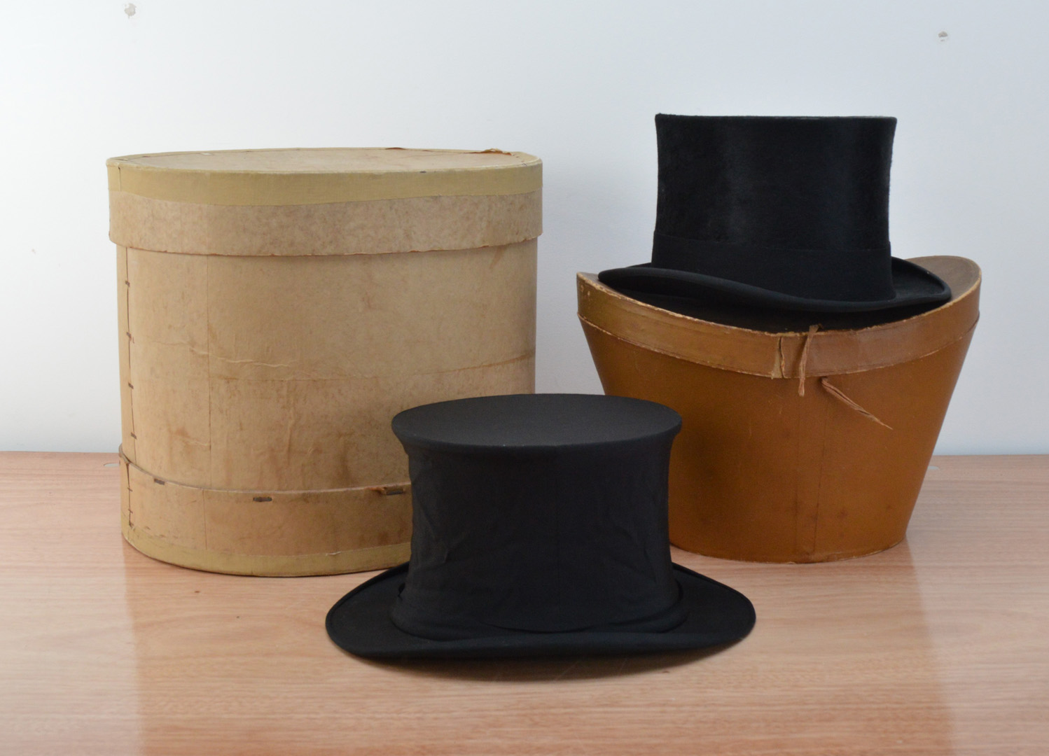 A Boxed silk top hat by W.J. Scotty Co. Ltd., together with a n Opera top hat by West & Co., all