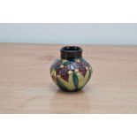 A Moorcroft pottery small squat vase, Trillium' pattern, 2000, 9cm high, in a retail box