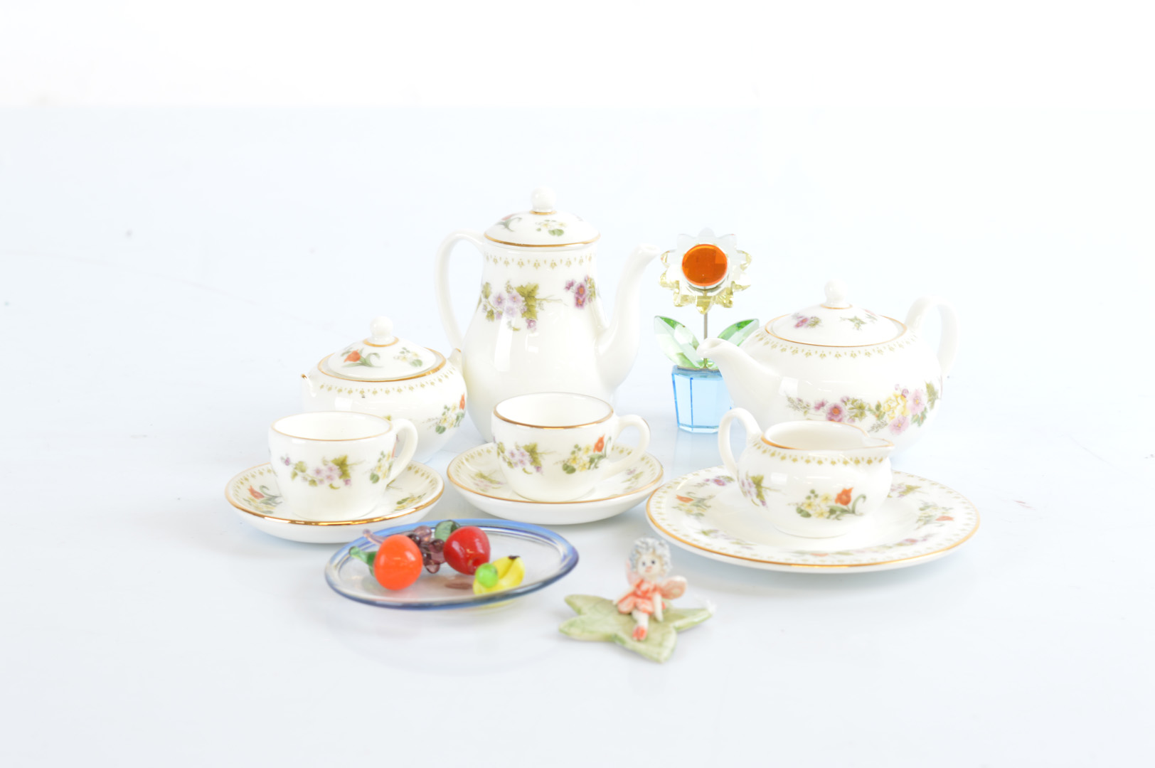 A Wedgwood china miniature tea for two, with a transfer printed floral decoration, a miniature glass