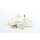 A Wedgwood china miniature tea for two, with a transfer printed floral decoration, a miniature glass