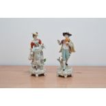 A pair of Sitzendorf porcelain figurines, male and female figurines, makers marks to the bases, both