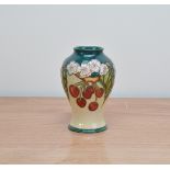 A Moorcroft pottery vase, Cherries' pattern, 1999, 16.5cm high, in a retail box