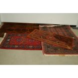 Four 20th century Middle Eastern woollen carpets, largest 182cm by 127cm (4)