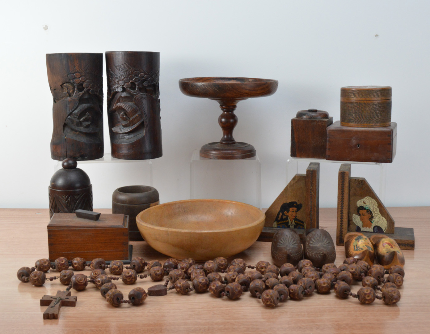 A large collection of wooden items, including a treen bowl, a pair of brush pots, a wooden cake