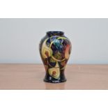 A Moorcroft pottery vase, Queens Choice' pattern, 16.5cm high, in its retail box