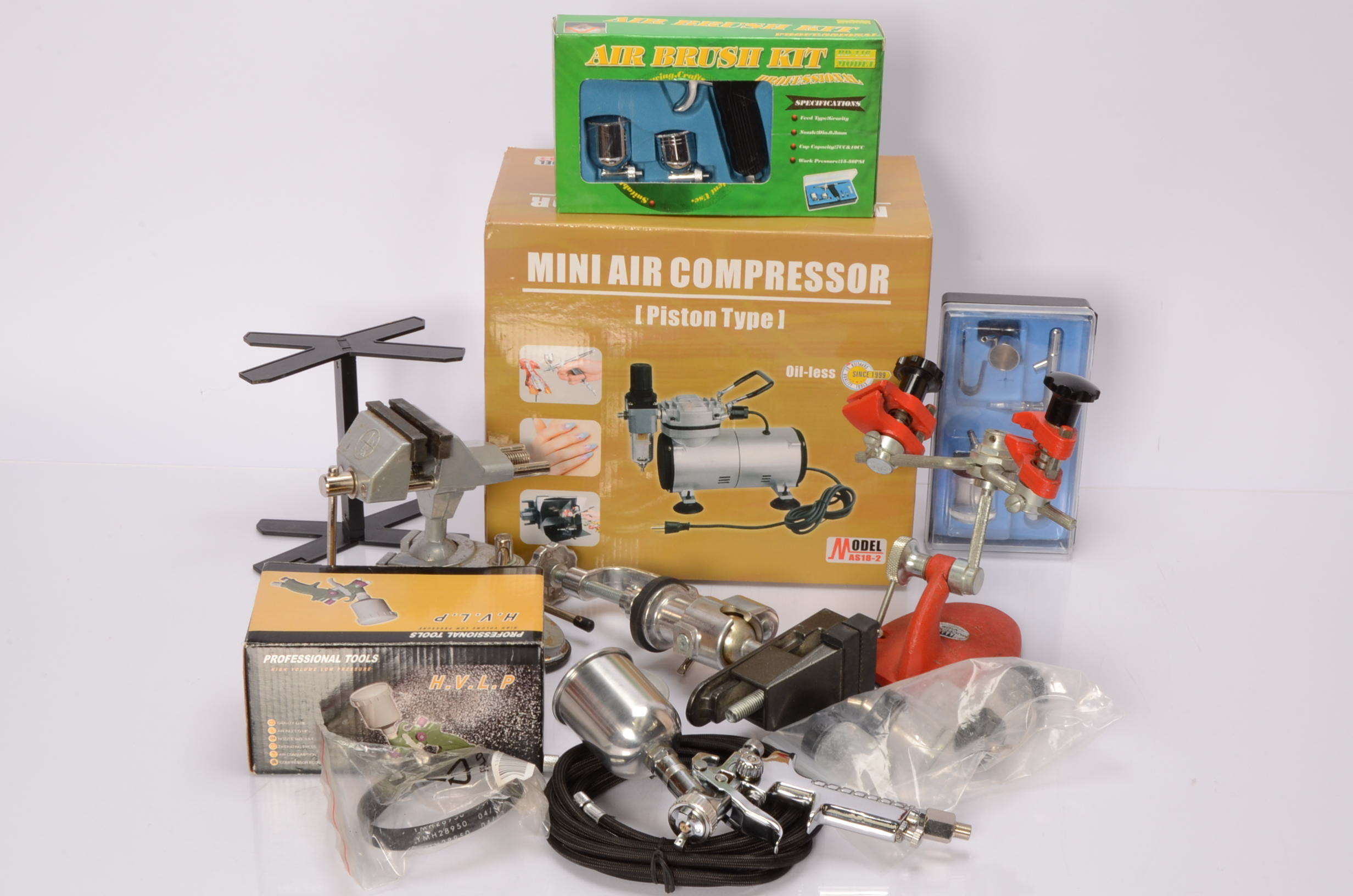 Collection of vices and paint compressors used for model boat kit building and painting,