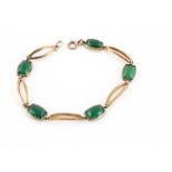 A 9ct gold and green chrysoprase set bracelet, the oval pierced links alternately set with green