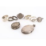 Two oval lockets, one engraved with horse shoe and crop, four silver bands, a silver flower signet