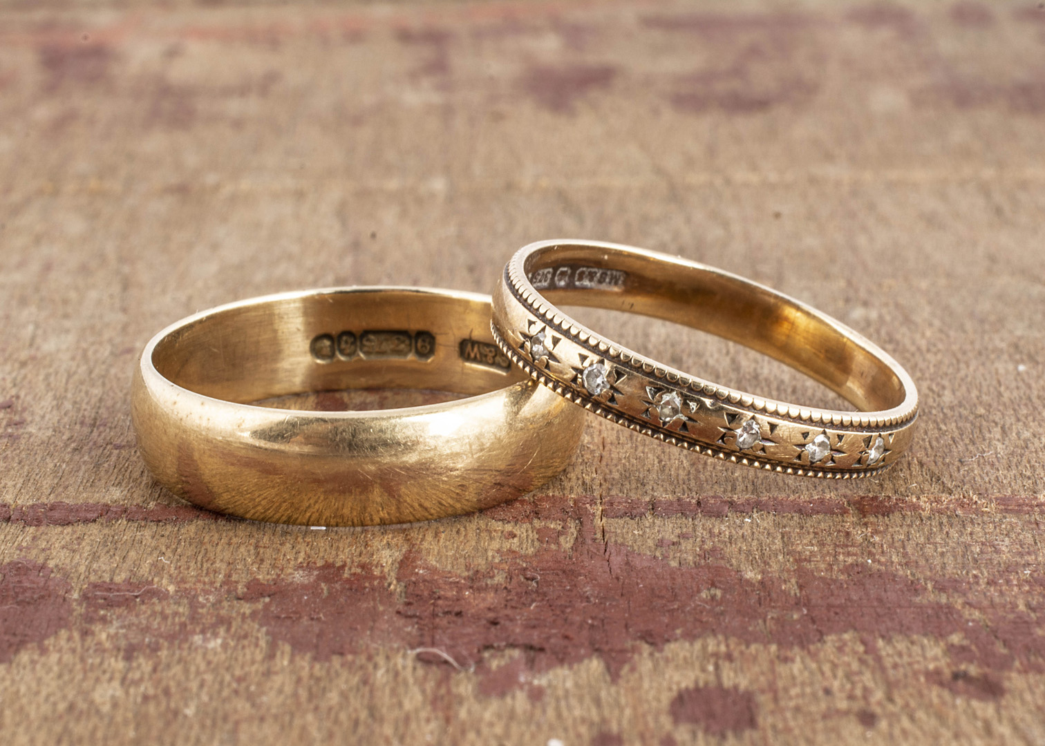 Two 9ct gold wedding bands, one set with small eight cut diamonds, the other D shaped, both ring