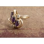 An amethyst and diamond cluster ring, oval mixed cut amethysts, and brilliants cuts, one setting