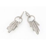 A pair of continental white metal and diamond chandelier drop earrings, the oval hoops with a