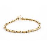 An 18ct gold and diamond line bracelet, satin finished links with small diamond set spacers, 19cm