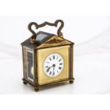 A vintage brass carriage time piece, with architectural style case, AF