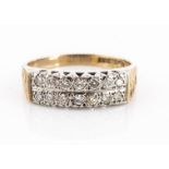 A 9ct gold double diamond band ring, two rows of brilliant cuts in a white metal gallery and setting