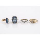 Four paste set dress rings, comprising a blue paste example, an opal ring, an illusion set signet