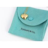 A Tiffany & Co 18ct marked full heart pendant and chain by Elsa Peretti, with pouch and box, pendant