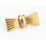 A continental yellow metal bow brooch, Art Deco in style, of bow design, of Middle Eastern origin,