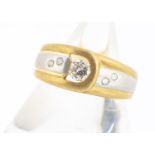 A continental two colour gold diamond dress ring, brilliant cut, in a textured matt buckle